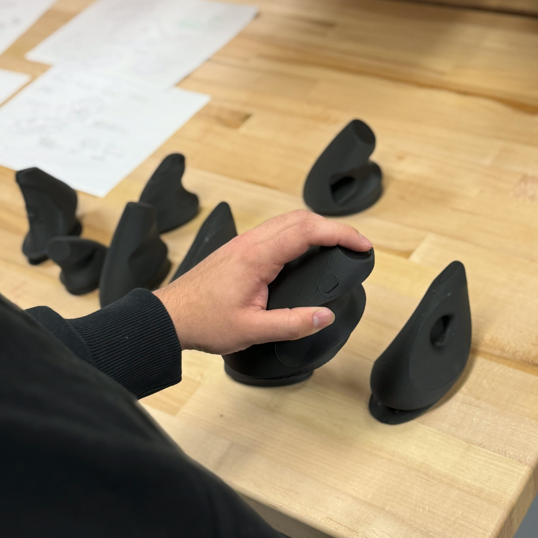 Participant mocking the injection motion against the forearm with a 3D-printed prototype